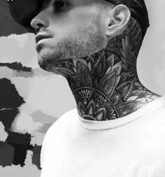 a man with tattoos on his neck wearing a white shirt and black hat, standing in front of an artistic background