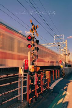 a train traveling down tracks next to a traffic light