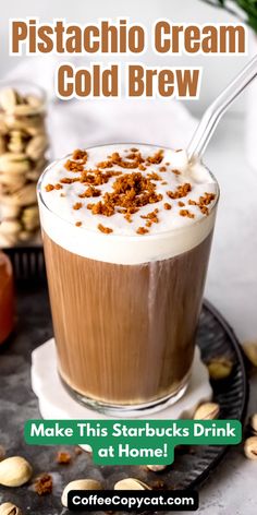 a cup of coffee with whipped cream and nuts on top