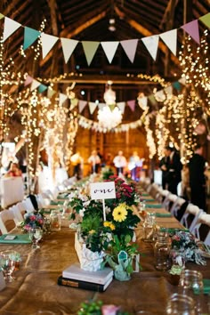 the tables are set with flowers and place settings for guests to sit down at them