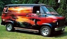 the van is painted red and black with an artistic design on it's side