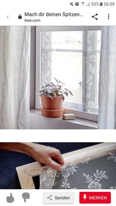 the screen is showing an image of a window with white curtains and a potted plant