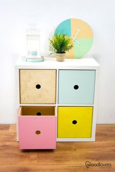 a multicolored dresser with a clock and plant on top