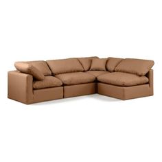 a brown leather sectional sofa with pillows on it's back and the seat folded out