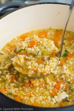 a ladle full of chicken and rice soup