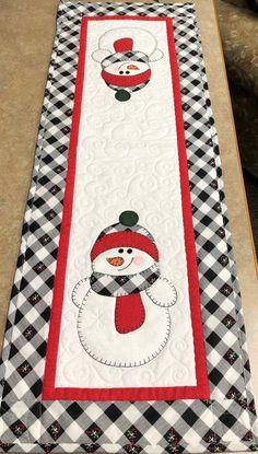 a table runner with a snowman on it