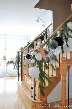 christmas decorations on the banisters and stairs in a house