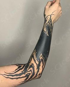 the arm is covered in black and white ink