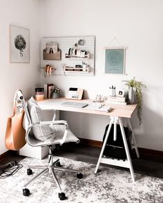 an office with a desk, chair, and pictures on the wall above it is shown