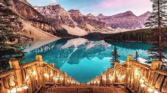 the stairs lead up to an amazing lake with mountains in the background and candles lit on them