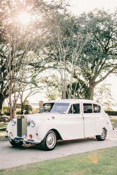 an old car is parked on the side of the road