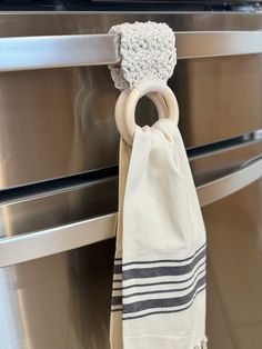 a towel hanging on the handle of an oven