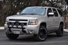 a silver truck is parked in a parking lot