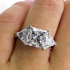 a woman's hand with a diamond ring on it