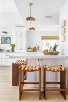 two wooden stools sitting on top of a kitchen counter