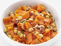 a white bowl filled with carrots and chickpeas