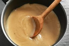 a wooden spoon in a pot filled with batter