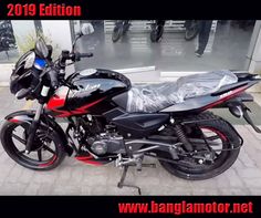 a black and red motorcycle parked in front of a building