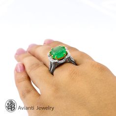 "This amazing soft glow of emerald gemstone really vows in this statement-sized ring. 18 karat yellow gold prongs, brings out the color of the Colombian green Emerald and it is surrounded by a halo of pave diamonds. This beautiful large emerald is set in yellow and white gold setting and it has split shank encrusted with diamonds. This ring is from our \"Red Carpet Collection\". [MATERIALS] Stone: Emerald Carat: 7.49 Clarity: Slight inclusions common to Emeralds Color: Colombian green Cut: Emera Luxury Open Emerald Ring With Prong Setting, Unique Emerald Ring With Prong Setting, Luxury Emerald Gemstone Ring Gift, Diamond Emerald Ring, Boulder Opal Necklace, Flower Diamond Ring, Emerald Gem, Emerald Diamond Ring, Opal Ring Gold