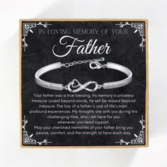 a silver bracelet with the words in loving memory of your father on it and an interlocked heart