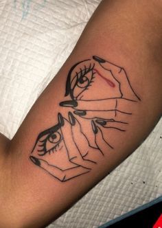 a woman's arm with a tattoo on it that has an image of two hands holding