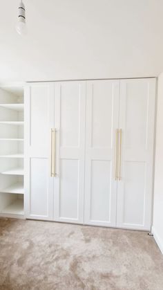 an empty room with white closets and carpeted flooring in the foreground