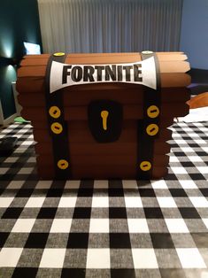 a cardboard fort made to look like a pirate chest with the words fortnite on it