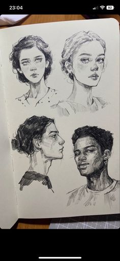 an open book with drawings of people on the pages, and one is drawn in pencil