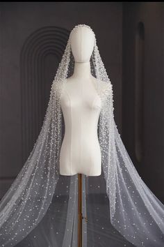 a white mannequin wearing a wedding veil