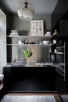 a kitchen with stainless steel counter tops and black cabinets