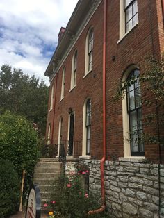 an old brick building with stone steps leading up to it