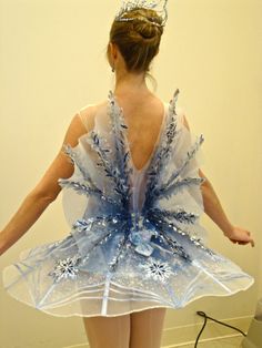 a woman in a dress made out of ice flakes and snowflakes