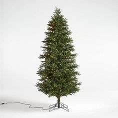 a small christmas tree with lights on it's branches is shown in front of a white background