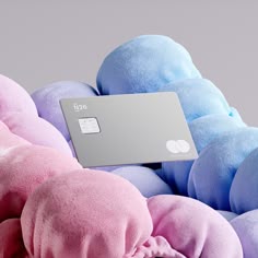 a pile of stuffed animals with a credit card on top