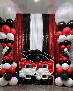 the balloon arch is decorated with black, white and red balloons