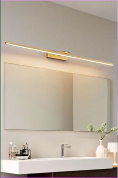 a bathroom sink with a mirror above it and a vase on the counter next to it