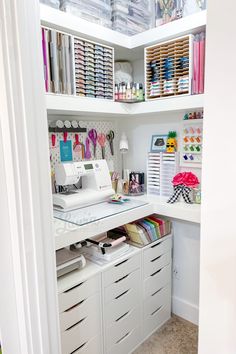 a sewing room with lots of crafting supplies on the shelves and in the closet