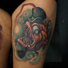 two tattoos on the legs of people with different colored inks, one has a clown face and is wearing a top hat