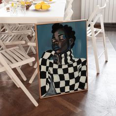 an image of a woman in black and white checkerboard dress sitting on the floor