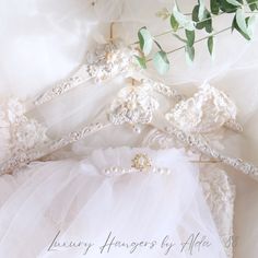 there is a bridal gown and flowers on the bed sheet that says luxury hangers for alopets