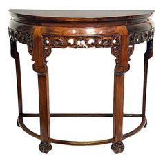 an ornately carved wooden table with marble top