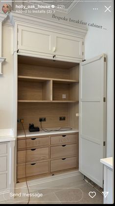 an open closet with white cabinets and drawers