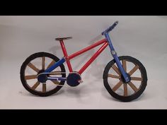 a red and blue bike with wooden spokes