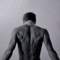 the back of a man's body with words on it that spellign ignite