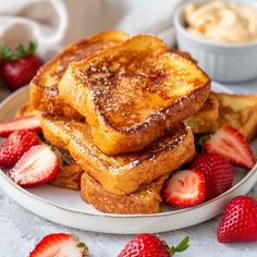 french toast with powdered sugar and strawberries on a plate