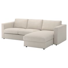 a white couch with a chaise lounger on the bottom right side and an ottoman in the middle