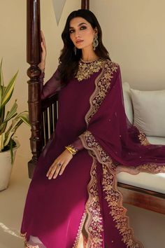 This 3-piece purple plum colored chiffon ensemble will elevate your festive fashion. The intricately hand-crafted neckline, and sleeves add a touch of skillful artistry to the kameez. The bright color is enhanced by exquisite gilded embroidery. The ensemble includes a silk trouser, and dupatta with beautiful embroidered details. Kameez fabric : embroidered chiffon with hand made neck and sleeve patch Trouser fabric : grip silk Dupatta fabric : embroidered chiffon Includes : shirt. trouser and du Embroidered Purple Dola Silk Salwar Kameez, Unstitched Purple Silk Suit With Embroidery, Purple Unstitched Embroidered Silk Suit, Purple Silk Dupatta With Intricate Embroidery, Purple Embroidered Floor-length Salwar Kameez, Eggplant Color Dress, Chiffon Suit, Bridal Dupatta, Pakistani Clothes Online