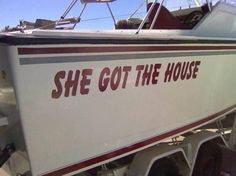 a white and red boat with the words she got the house on it's side