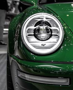 the front end of a green car on display