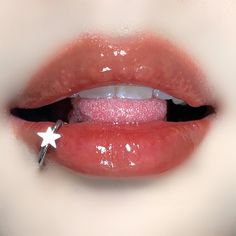 a close up of a person's mouth with a star on the tip of their lip